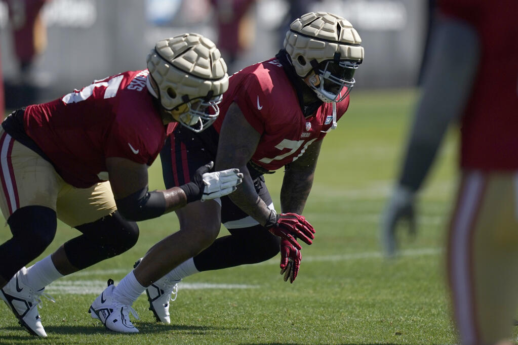 San Francisco 49ers guard Aaron Banks, left, and offensive tackle Trent Williams take part in drills at the NFL football team's practice facility in Santa Clara, Calif., Friday, Aug. 5, 2022. (AP Photo/Jeff Chiu)