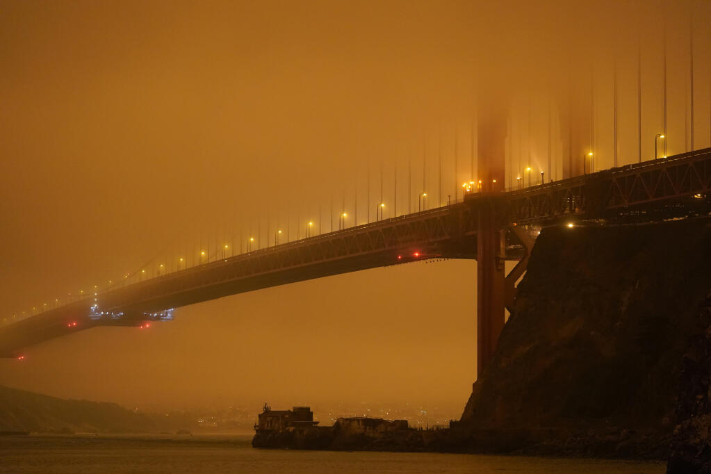 The Golden Gate Bridge is barely visible through smoke from wildfires Wednesday, Sept. 9, 2020, in this view from Fort Baker near Sausalito, Calif. (AP Photo/Eric Risberg)