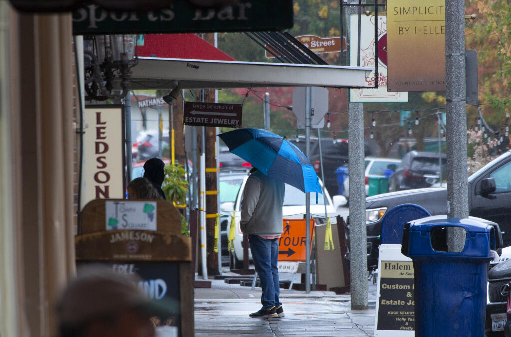 After a long period of drought, umbrellas were out in full force on First Street East on the Plaza in Sonoma, shielding people from the long-awaited rain on Wednesday morning, Oct. 20, 2021. (Photo by Robbi Pengelly / Index-Tribune)