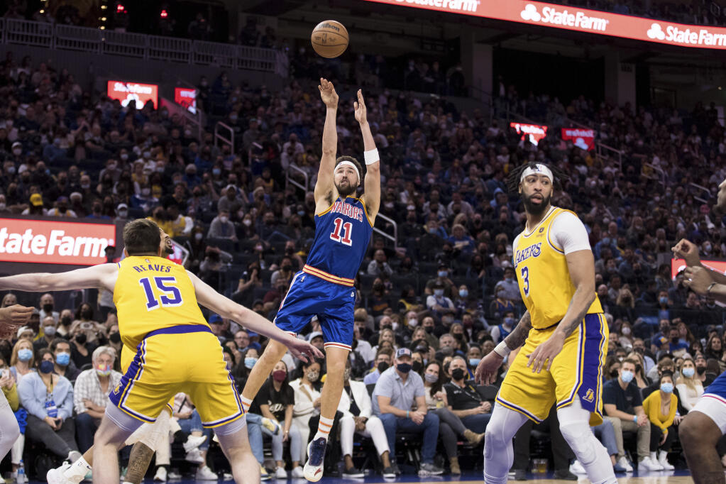 Golden State Warriors guard Klay Thompson takes a three-point shot over Los Angeles Lakers guard Austin Reaves during the second half in San Francisco on Saturday, Feb. 12, 2022. The Warriors won 117-115. (John Hefti / ASSOCIATED PRESS)