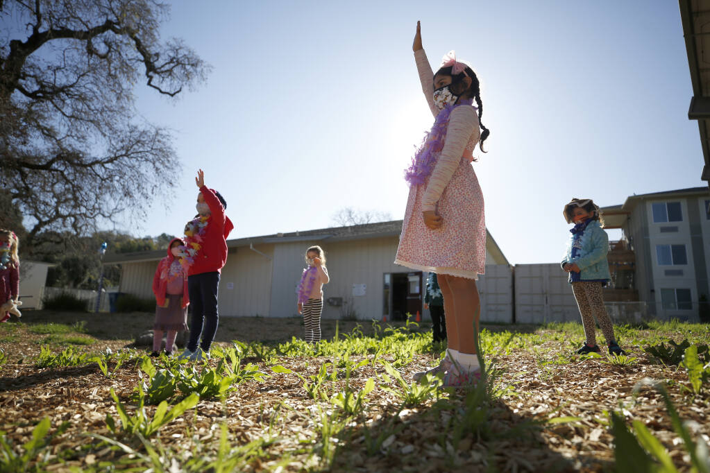First grader Silvana Rodriguez, 7, raises her hand to answer a question about what to do during a fire or natural disaster on the first day of in-person learning Sonoma Charter School in Sonoma, Calif., on Monday, March 1, 2021. (Beth Schlanker/ The Press Democrat)
