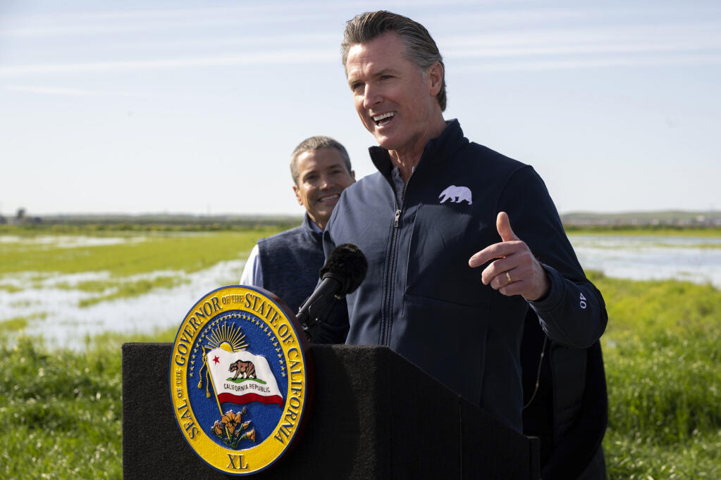 California Gov. Gavin Newsom talks during a news conference from a farm in Dunnigan, Calif., Friday, March 24, 2023. Newsom announced an end to some drought restrictions and calls for water conservation, following a series of winter storms have dramatically improved the state's water supply outlook. (Paul Kitagaki Jr./The Sacramento Bee via AP)