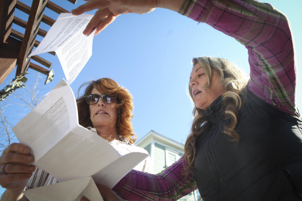 Lauren Franco, who lives next to a Muir Wood Adolescent and Family Services Center on Skillman Lane, shows her friend and neighbor Lesha Bertolucci the letter she wrote to discourage the proposed expansion of the center. She handed out more than 80 letters throughout the rural Petaluma neighborhood._Friday, February 04, 2022._Petaluma, CA, USA._(CRISSY PASCUAL/ARGUS-COURIER STAFF)
