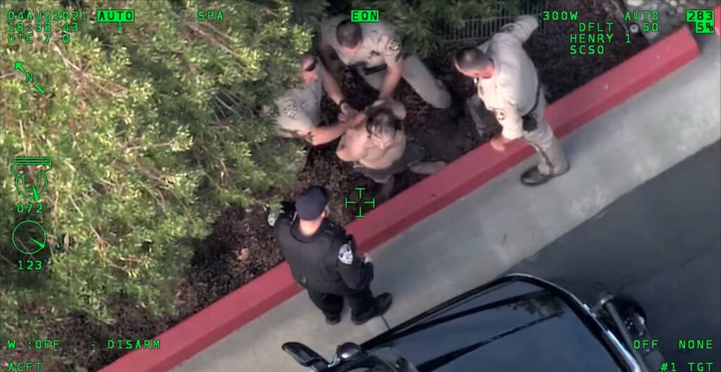A video taken from the Sonoma County Sheriff’s Office helicopter Henry 1 shows police arresting a DUI suspect who hid in a storm drain after running from the scene of a car crash on Highway 101 in Petaluma, California on Wednesday, Aug. 4, 2021. (Sonoma County Sheriff’s Office/Facebook)