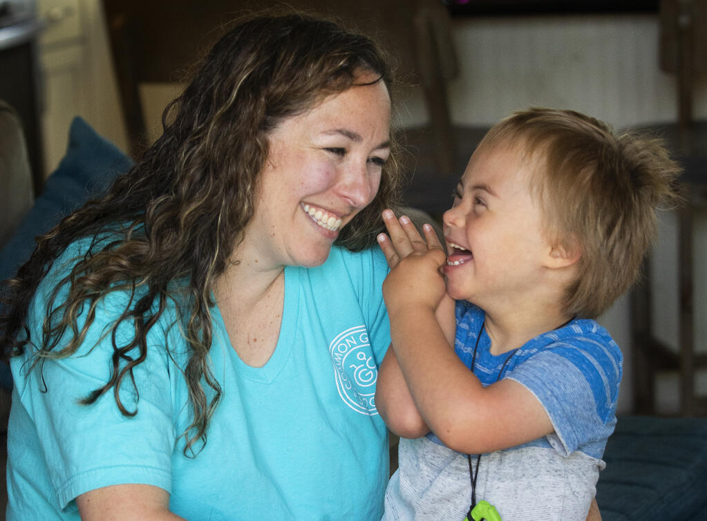 Larkin O'Leary plays with her son, James, 7, who has Down syndrome, in their Santa Rosa home on Friday, May 28, 2021. O'Leary is the co-founder of the Common Ground Society - a nonprofit group offering support for families with children with developmental disabilities along with offering education to schools, businesses and groups about special needs kids. (John Burgess/The Press Democrat)