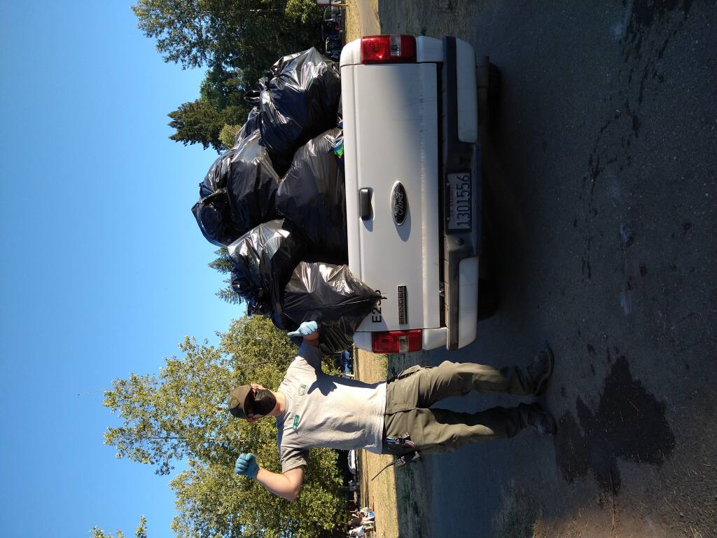Sonoma County Regional Parks Aide Michael Stanford hauls in mounds of trash from Steelhead Beach in Forestville over the Fourth of July holiday. Photo by Jessica Saler