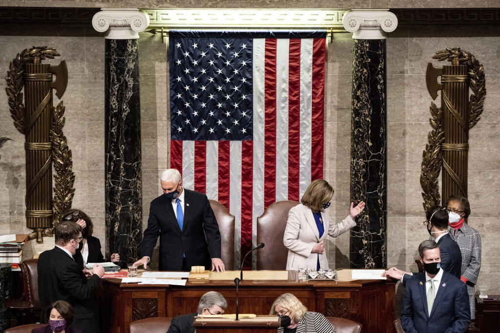 Vice President Mike Pence and House Speaker Nancy Pelosi reconvene to confirm the 2020 presidential election results after a mob of supporters of President Donald Trump attacked the Capitol on Jan. 6, 2021. (ERIN SCHAFF / New York Times)