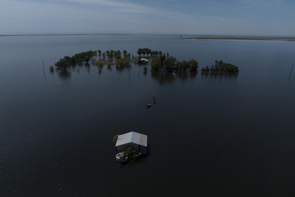 FILE - Farmland in the Tulare Lake Basin is submerged in water in Corcoran, Calif., April 20, 2023, after more than a dozen atmospheric rivers dumped record-setting rain and snowfall. Nearly half of the U.S. West has emerged from drought, but intense water challenges persist, scientists said Tuesday, May 9. (AP Photo/Jae C. Hong, File)