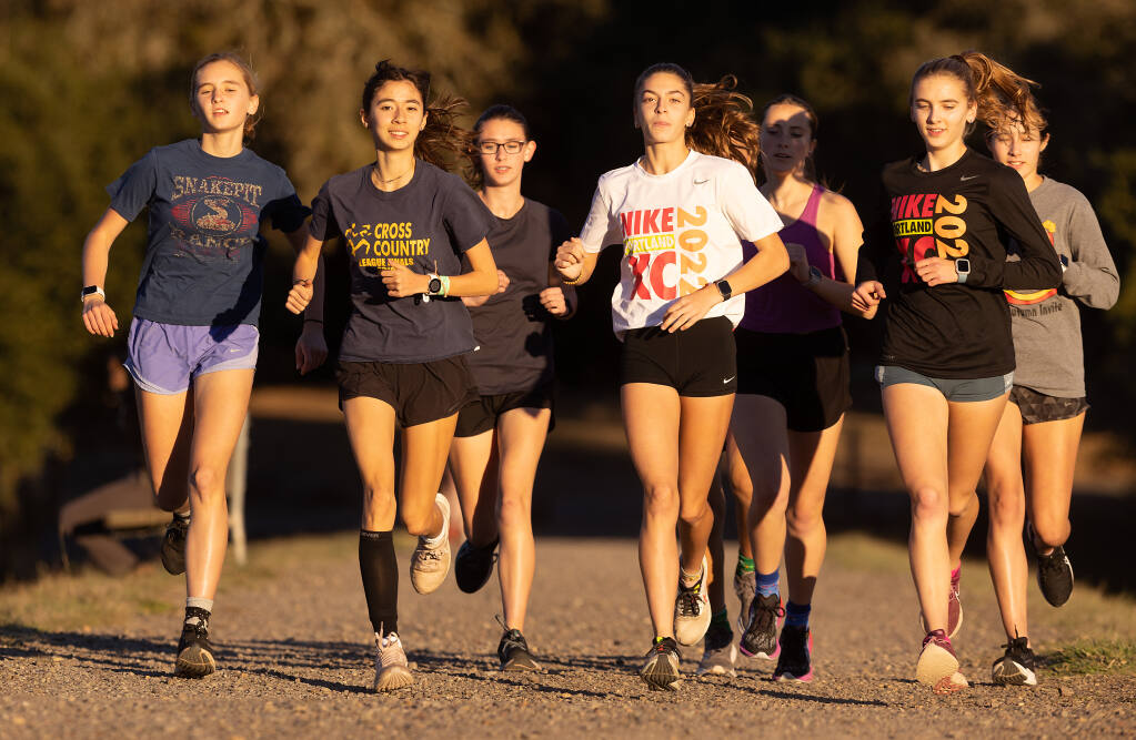 Montgomery sophomore and No. 1 runner Hanne Thomsen, second from left, leads the cross country team on a recovery run at Spring Lake in Santa Rosa Tuesday Nov. 15, 2022. The team heads to the North Coast Section Cross Country Championships on Saturday in Hayward. (John Burgess / Press Democrat)