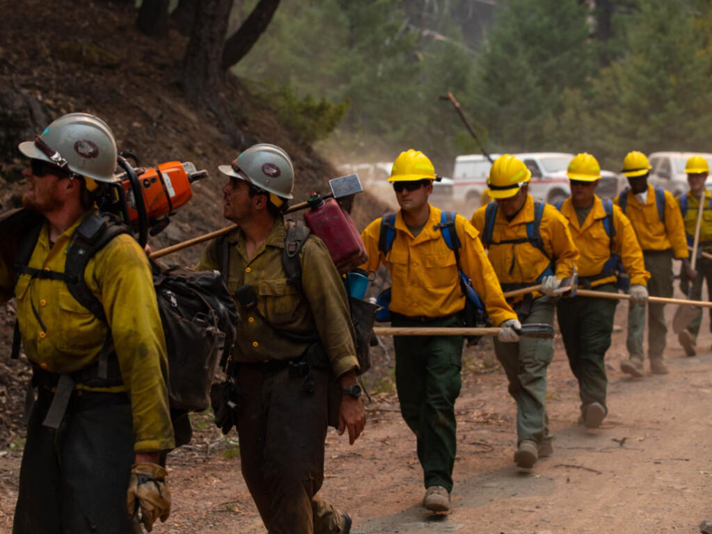 Sawyers from the Billings IA, a Bureau of Land Management Type 2 Initial Attack crew, leads firefighting soldiers to another area of the containment line that needs brush removed adjacent to a containment line about five miles northeast of the Eel River Campground  on Sunday, Sept. 6, 2020. (U.S. Forest Service - Mendocino National Forest / Courtesy of the Army).