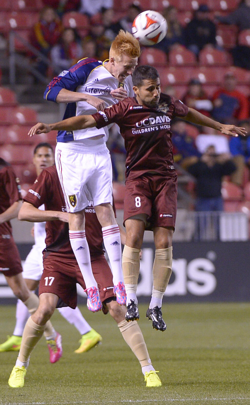 FILE - Real Salt Lake defender Justen Glad, left, and Sacramento Republic FC midfielder Rodrigo Lopez (8) make a header during an exhibition game at Rio Tinto Stadium in Sandy, Utah, Tuesday, Sept. 30, 2014. Rodrigo Lopez was on the field the night Sacramento Republic FC debuted as a franchise nearly a decade ago, filling venerable, old Hughes Stadium to the brim. It was a memorable night and the start of a magical season that ended with a USL championship. (Leah Hogsten/The Salt Lake Tribune via AP, File)