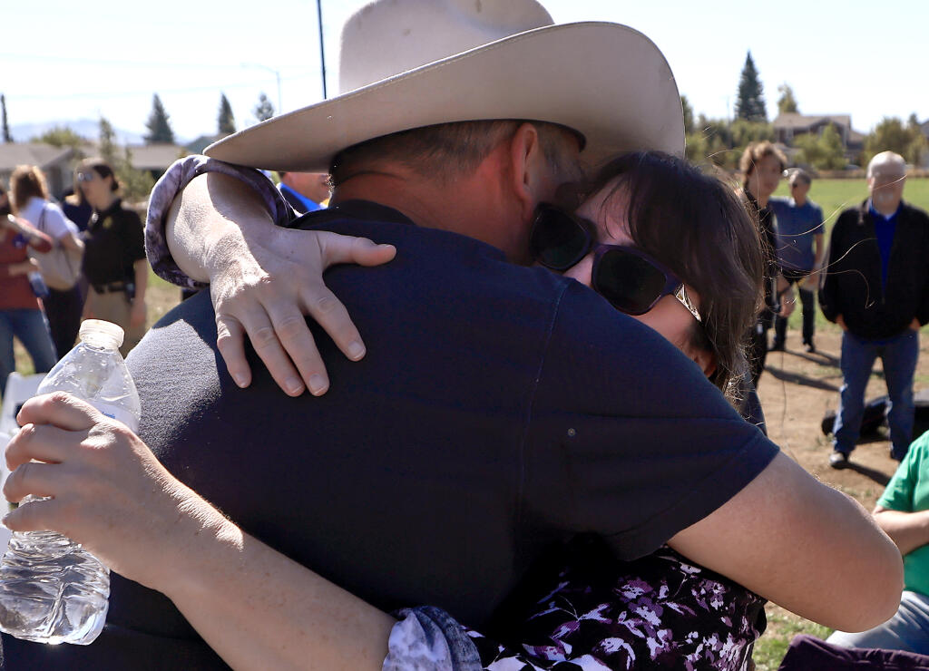 Jessica Tunis, whose mother Linda Tunis died in the Tubbs Fire, embraces Houston Evans, whose mother also died in the fire, Saturday, Oct. 8, 2022, after a ceremony marking the five-year anniversary of the Tubbs Fire at Coffey Park in Santa Rosa. (Kent Porter / The Press Democrat) 2022