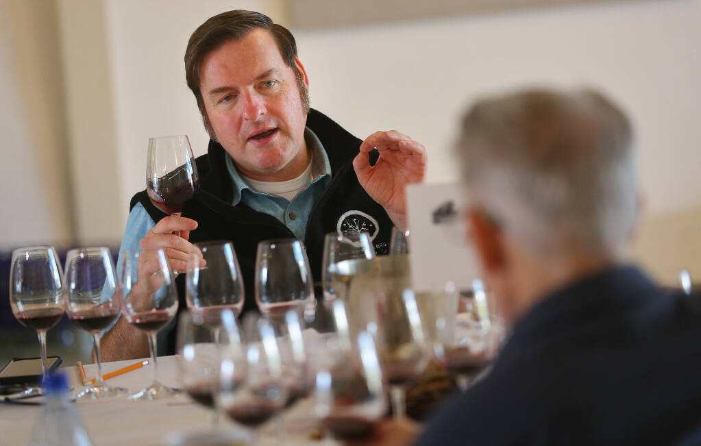 Christopher Sawyer talks about a wine during Sonoma County Harvest Fair Wine Competition judging at the Sonoma County Fairgrounds in Santa Rosa on Tuesday, Sept. 14, 2021.  (Christopher Chung/ The Press Democrat)