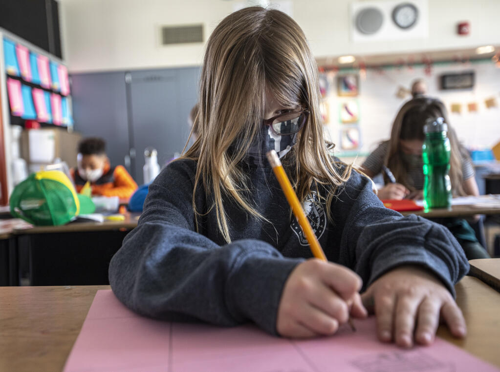 Village Elementary School third grader Kelly Duellge wears a face mask while working on an art project during independent study in Sarah McBride’s class in Santa Rosa, Monday Feb. 28, 2022. (Chad Surmick / The Press Democrat)