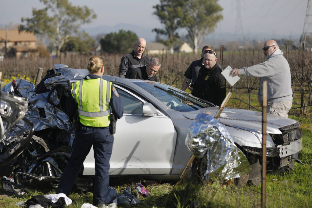 Law enforcement personnel investigate the scene of a fatal crash on Hwy 116 just west of Watmaugh Road near Sonoma, Calif., on Sunday, January 16, 2022. (Beth Schlanker / The Press Democrat)