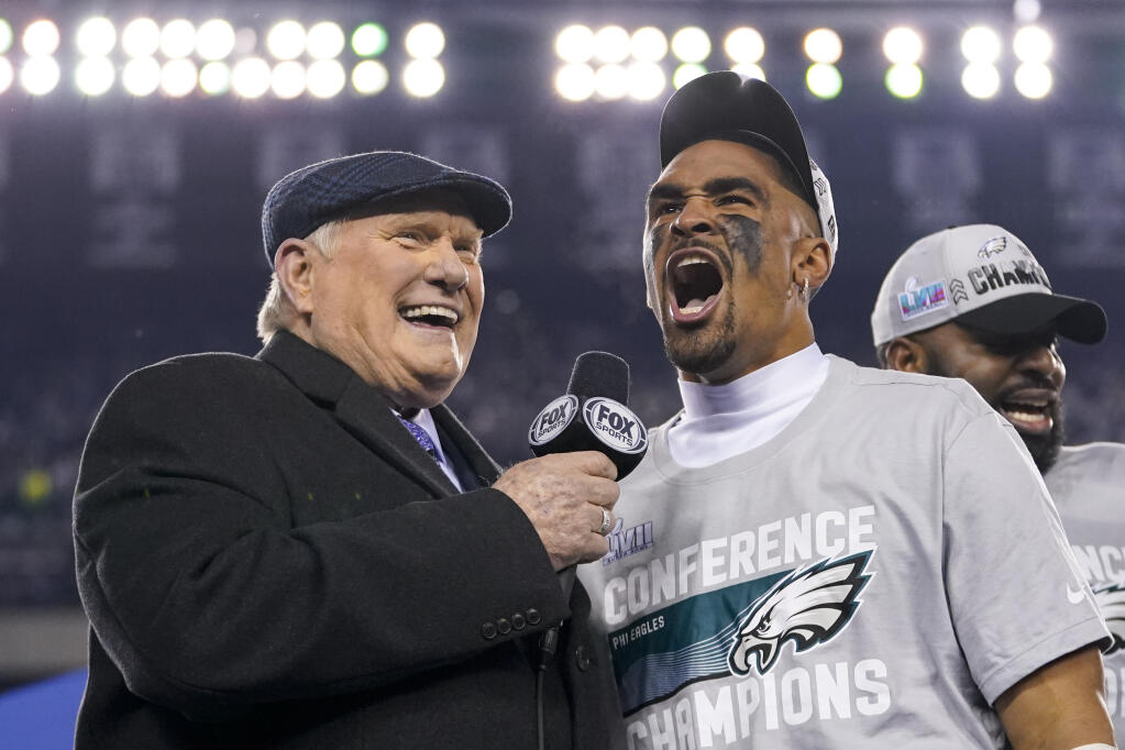Philadelphia Eagles quarterback Jalen Hurts, center, reacts while speaking toTerry Bradshaw, left, after the NFC Championship NFL football game between the Philadelphia Eagles and the San Francisco 49ers on Sunday, Jan. 29, 2023, in Philadelphia. The Eagles won 31-7. (AP Photo/Matt Slocum)