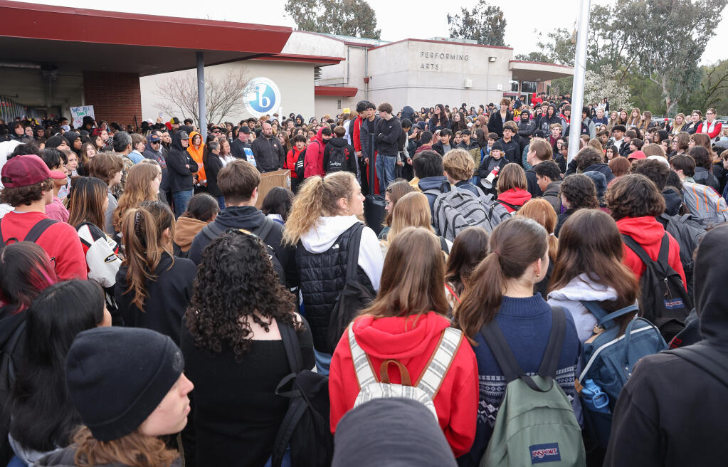 Students gather around the front of Montgomery High School to listen to speakers after staging a walkout in Santa Rosa, Monday, March 6, 2023.  (Christopher Chung / The Press Democrat)