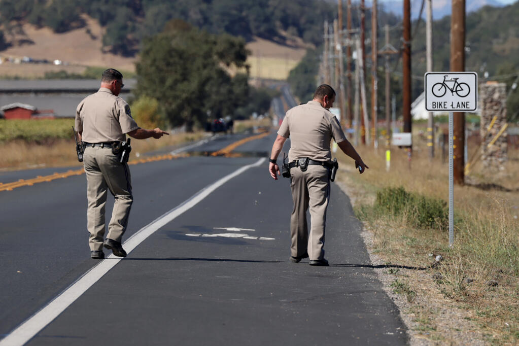 California Highway Patrol officers work at the scene after a male and female cyclist were struck and killed by a farm truck on Silverado Trail in Napa, Tuesday, Oct. 17, 2023. (Beth Schlanker / The Press Democrat file)