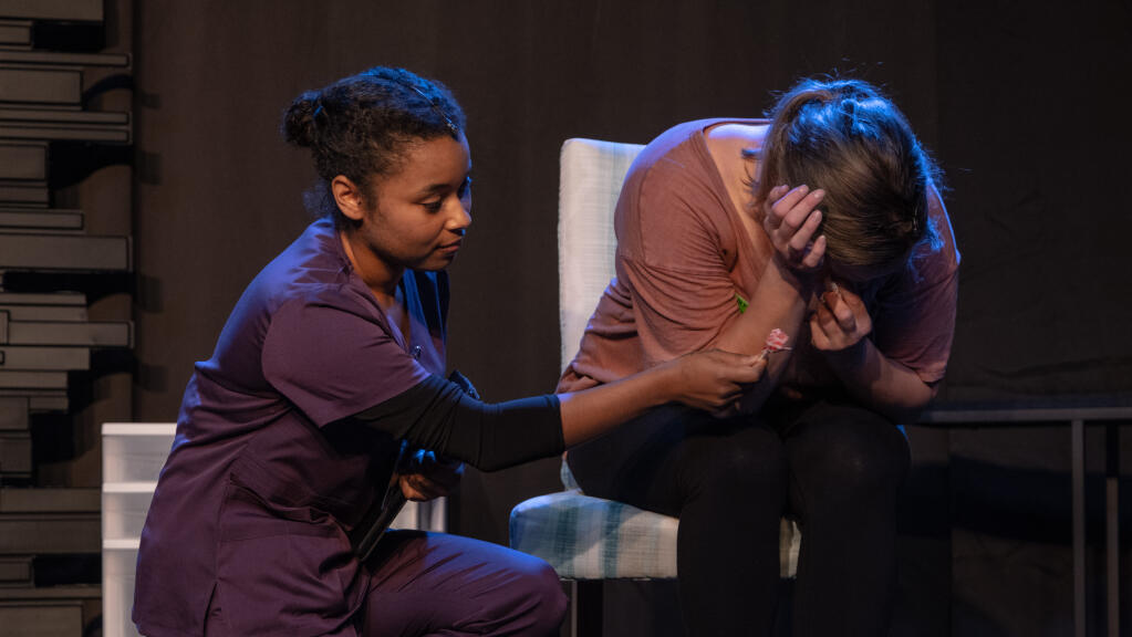 A hospital therapist played by Lexus Fletcher, left, consoles an upset mother played by Caitlin Strom-Martin in “Mary Jane.” (Dana Hunt)