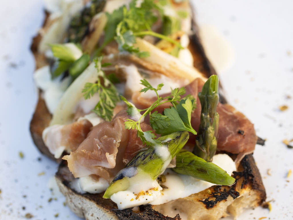 Roasted Veggie Toast appetizer with asparagus, prosciutto and pine nuts over sage Straus cream from Wit & Wisdom Sonoma.  (John Burgess/The Press Democrat)