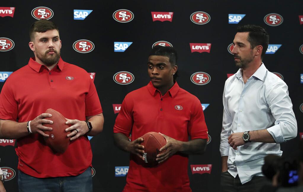 San Francisco 49ers coach Kyle Shanahan, right, stands with the NFL football team's newest players, Weston Richburg, left, and Jerick McKinnon, after a news conference Thursday, March 15, 2018, in Santa Clara, Calif. (AP Photo/Ben Margot)
