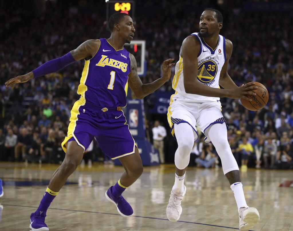 The Golden State Warriors' Kevin Durant, right, is defended by the Los Angeles Lakers' Kentavious Caldwell-Pope during the second half Wednesday, March 14, 2018, in Oakland. (AP Photo/Ben Margot)