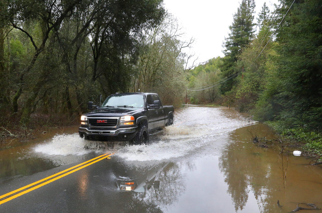 A truck makes it through a flooded Eastside Road, west of Windsor, on Tuesday, February 26, 2019. The road was closed due to flooding. (Christopher Chung/ The Press Democrat)