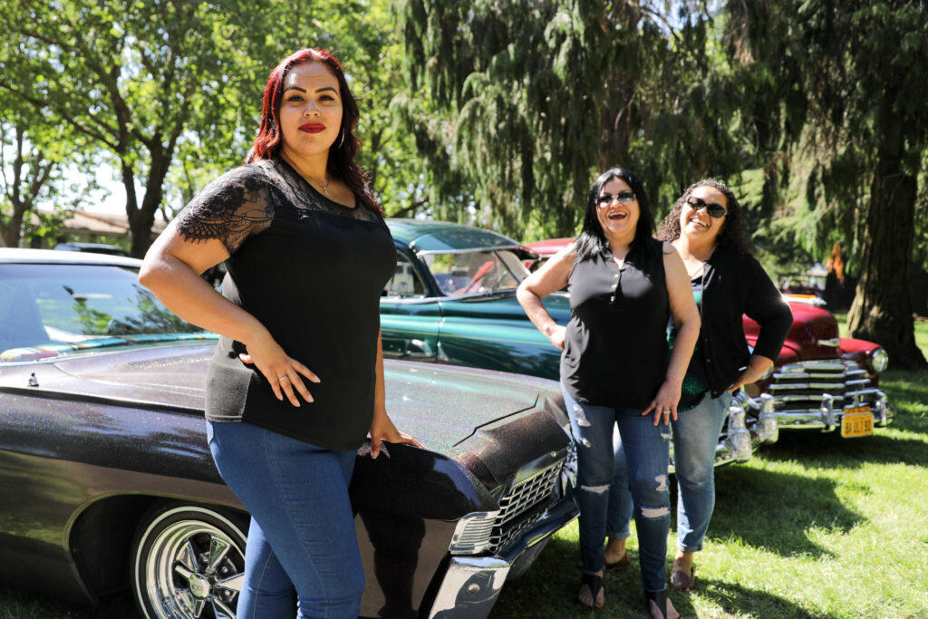 From left to right: Raquel Sanchez, Annie Reyes and Teresa Castillo in front of their lowriders at Julliard Park, Santa Rosa. Ricardo Ibarra / La Prensa Sonoma