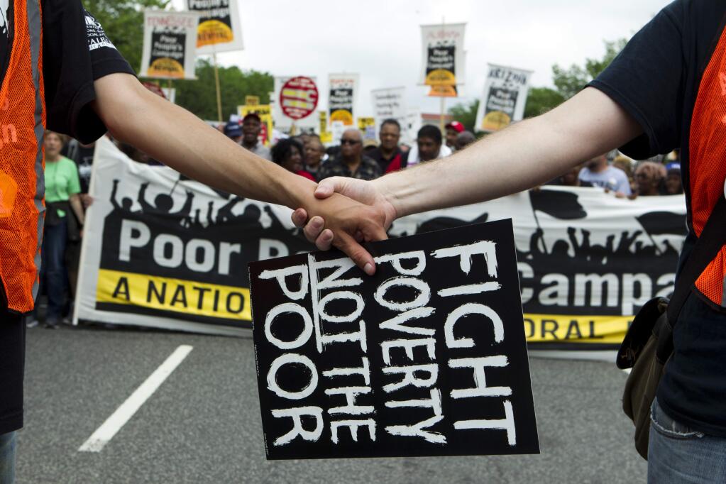A banner in the Poor People's March in June in Washington. (JOSE LUIS MAGANA / Associated Press)