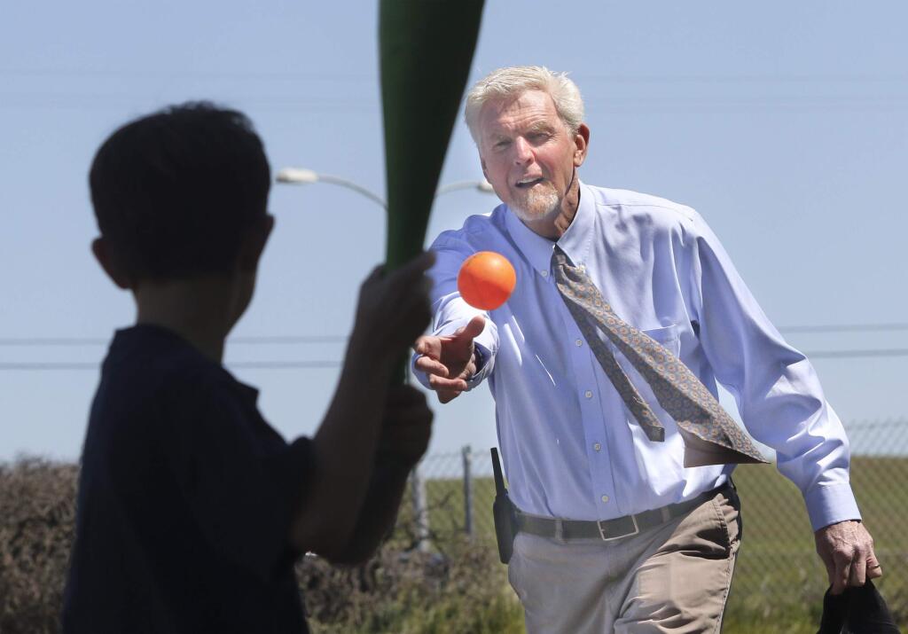 Two Rock Elementary School Principal Michael Simpson pitches a wiffle ball to a student during after lunch recess on Tuesday, April 14, 2015. (SCOTT MANCHESTER/ARGUS-COURIER STAFF)