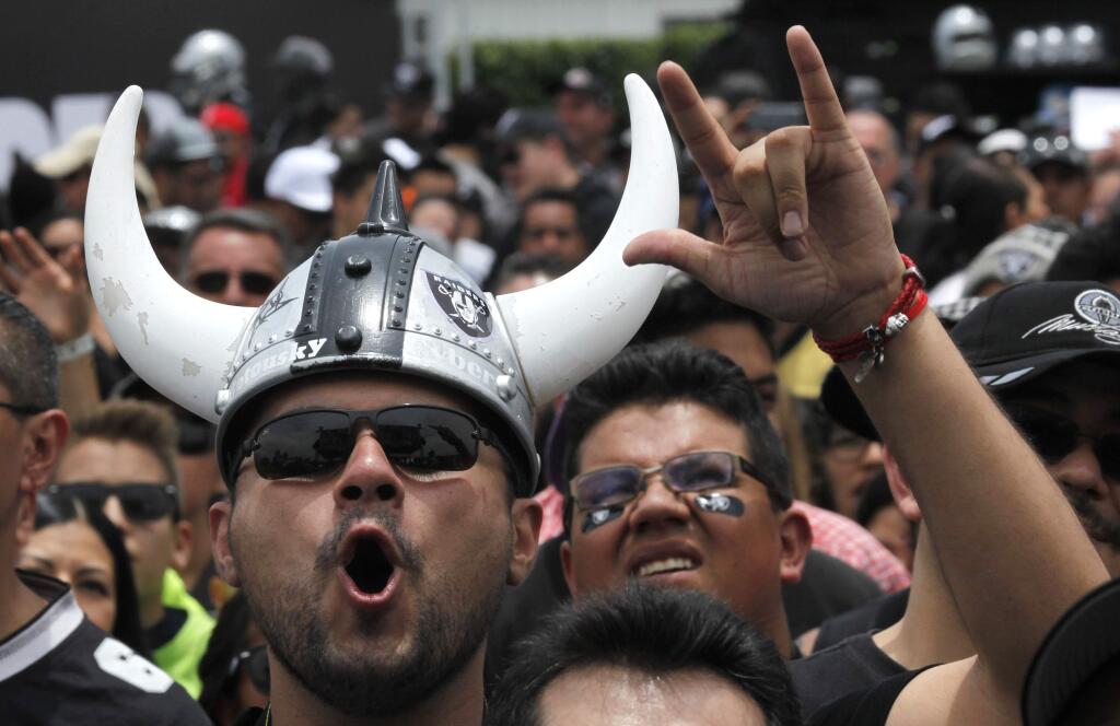 Oakland Raiders fans cheer during an event with the team's players where they announced their third day NFL picks at Azteca Stadium in Mexico City, Saturday, April 30, 2016. The Raiders will play the Houston Texans at Azteca on Nov. 21, 2016, during the NFL regular season. (AP Photo/Marco Ugarte)