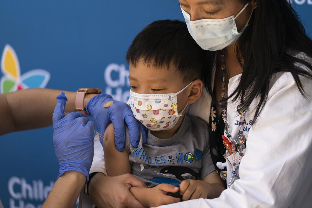 Aevin Lee, 2, received the Pfizer COVID-19 vaccine in the arms of his mother, Dr. Jennifer Su, at Children's Hospital Los Angeles on June 21, 2022. Photo by Jae C. Hong, AP Photo