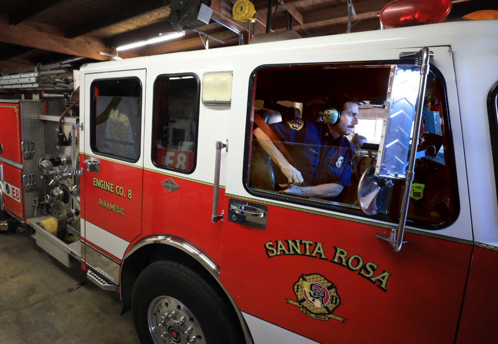 At the Roseland Fire Department, Santa Rosa’s station 8, Tuesday, April 9, 2019 captain Mike Harrison puts his seatbelt on as the crew prepares for a drill rotation. (Kent Porter / Press Democrat) 2019