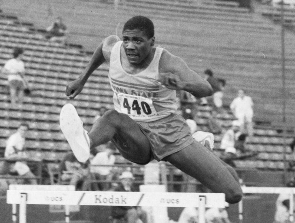 FILE - In this June 18, 1984, file photo, Iowa State University's Danny Harris, of Perris, Calif., clears a hurdle on his way to a second place finish in the men's 400-meter hurdles during the U.S. track and field trials in Los Angeles. Harris earned silver in the 400-meter hurdles at the 1984 Olympics in Los Angeles behind legendary hurdler Edwin Moses, who won gold. Harris was charged Tuesday, June 6, 2017, with contacting a teenage girl to commit a sex crime while he was a Southern California high school coach. (AP Photo, File)