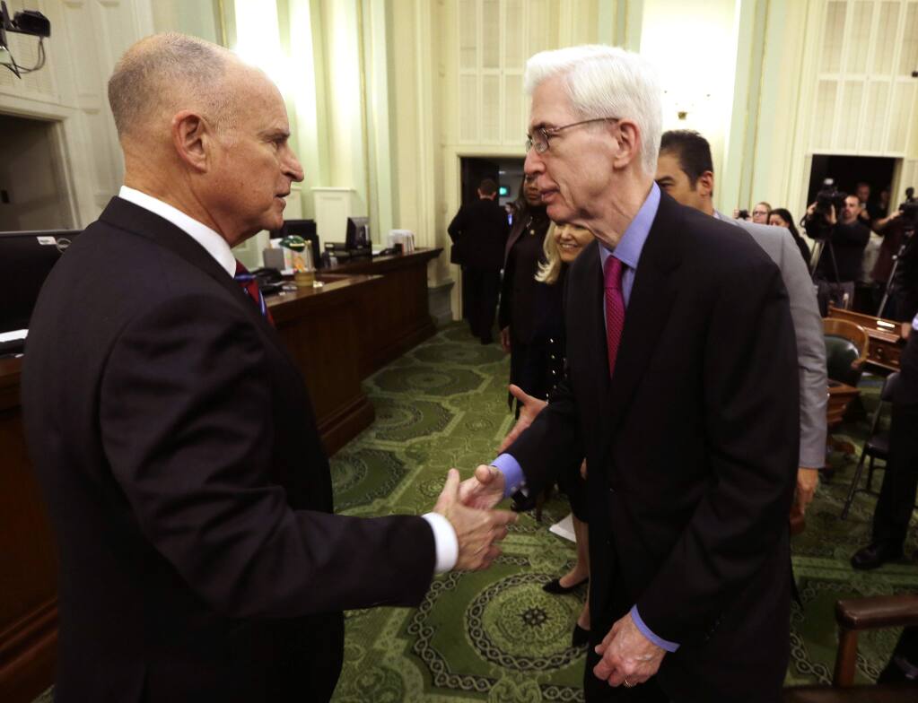 California Gov. Jerry Brown, left, is greeted by former Gov. Gray Davis, right, after his inauguration at the state Capitol Monday, Jan. 5, 2015, in Sacramento, Calif. When Brown takes the oath of office Monday, it will be the first time a California governor will be sworn in to a fourth term. The 76-year-old Democrat, who held office from 1975 to 1983 before term limits and returned for a third term in 2011, delivered a joint inauguration and state of the state address in the Assembly chamber at the state Capitol. (AP Photo/Rich Pedroncelli, Pool)