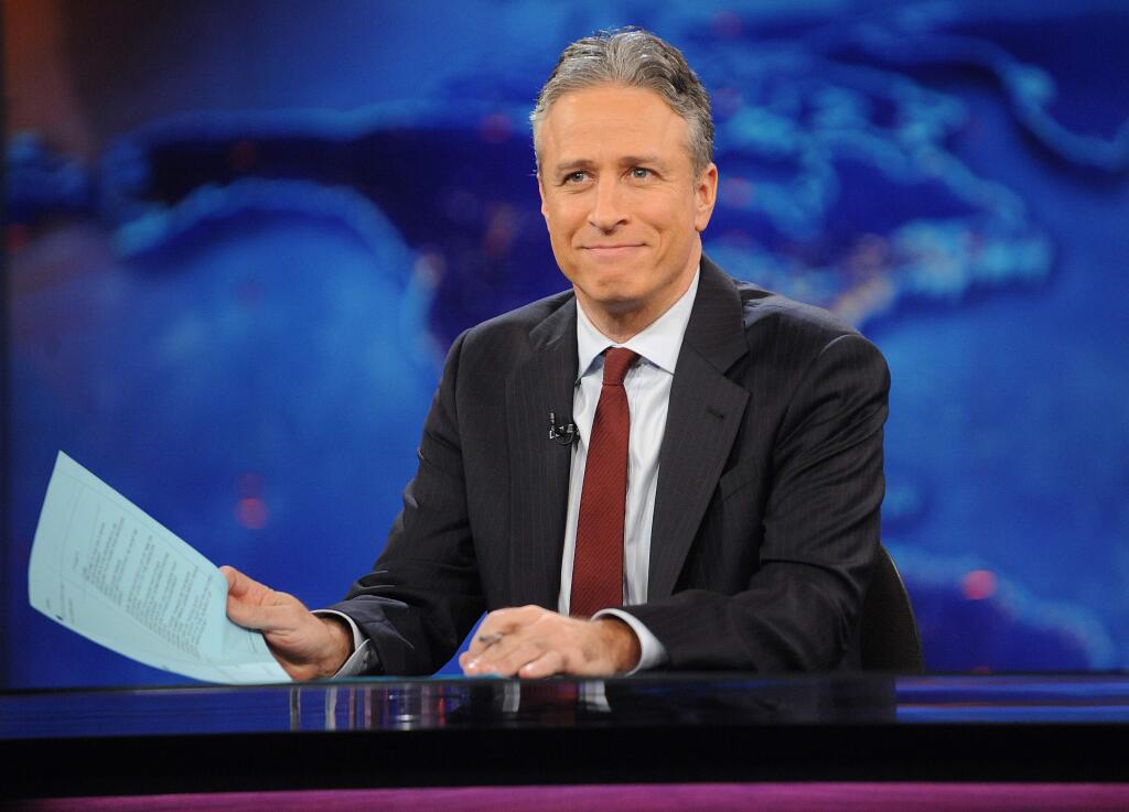 FILE - This Nov. 30, 2011 file photo shows television host Jon Stewart during a taping of 'The Daily Show with Jon Stewart' in New York. Stewart says Aug. 6, 2015 will be his last night hosting Comedy Centralís ìThe Daily Show.î Stewart set the date in the closing moments of Monday, April 20 edition of the parody newscast. (AP Photo/Brad Barket, file)