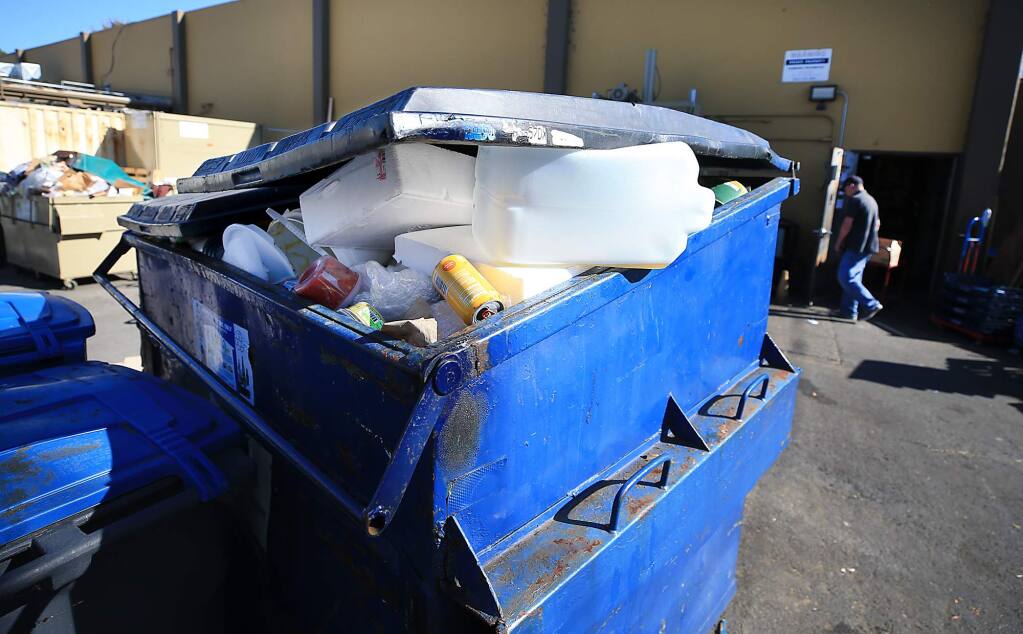 Non-recyclable trash including styrofoam and plastic bags are discarded in a recycling bin behind Pacific Market in Sebastopol on Wednesday, Oct. 17, 2018. (KENT PORTER/ PD)