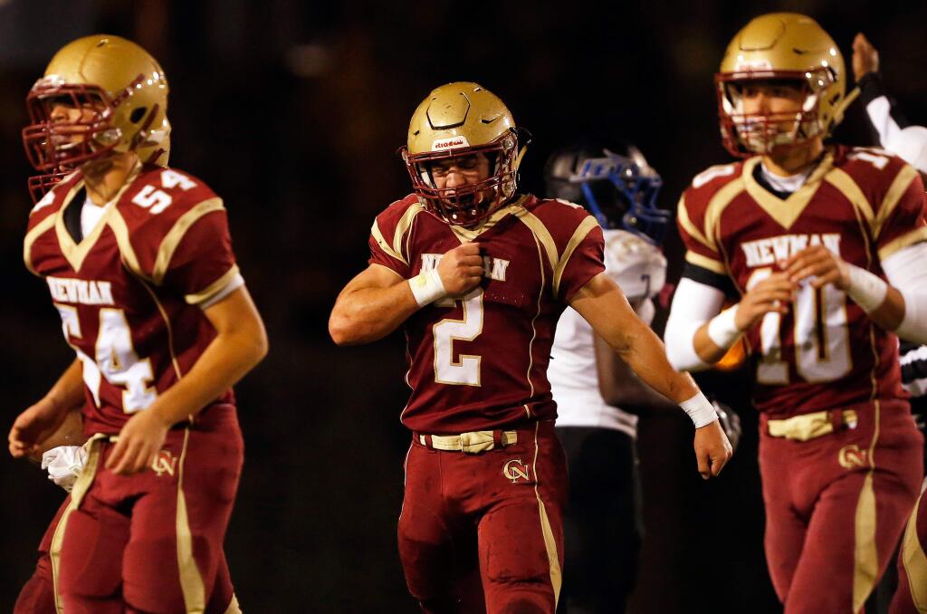 Cardinal Newman's Tanner Mendoza, center, celebrates causing an Encinal turnover during the first half of the NCS Division 3 varsity football quarterfinal game in Santa Rosa on Friday, Nov. 17, 2017. (Alvin Jornada / The Press Democrat)