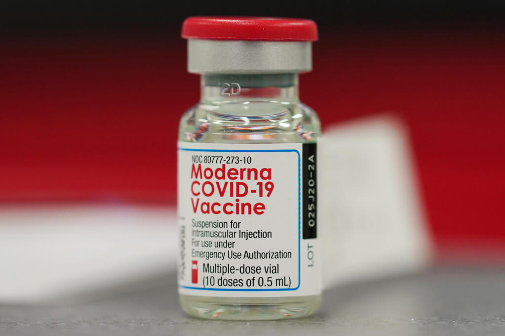 A vial of the COVID-19 vaccine from Moderna sits on a table top to be used in vaccinating employees in the first round of staff vaccinations at Rose Medical Center Wednesday, Dec. 23, 2020, in Denver. (AP Photo/David Zalubowski)