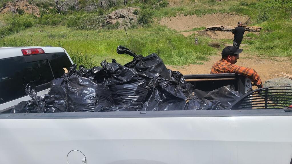 A crew of 10 gun enthusiasts, organized by Brendan Pankow and Kyle Scally, spent six hours, Sunday, May 21, 2023, cleaning up a trashed shooting range high up on Pine Flat Road, northeast of Healdsburg. (Photo courtesy of Kyle Scally)