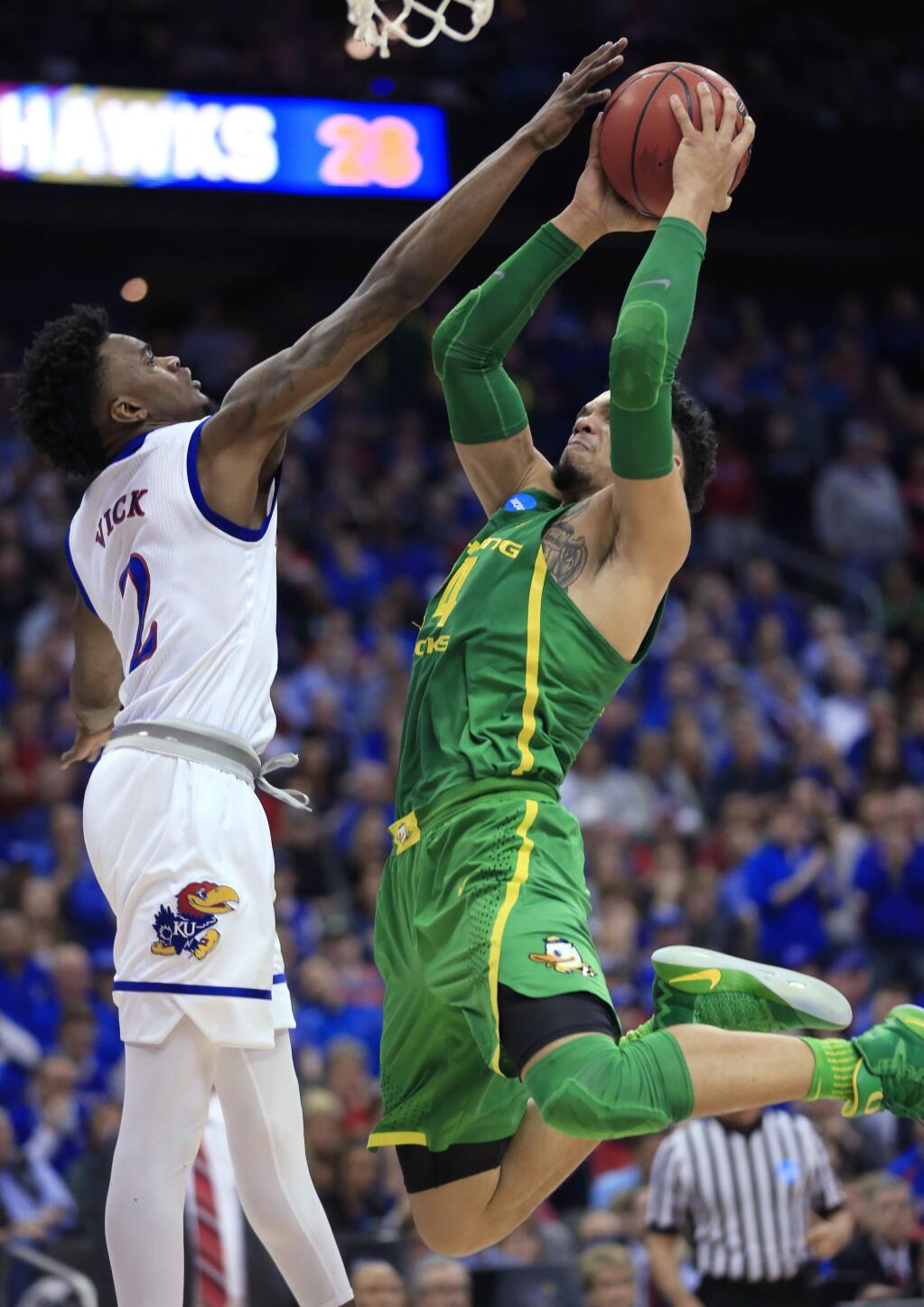Oregon forward Dillon Brooks, right, shoots over Kansas guard Lagerald Vick during the first half of the Midwest Regional final of the NCAA tournament, Saturday, March 25, 2017, in Kansas City, Mo. (AP Photo/Orlin Wagner)