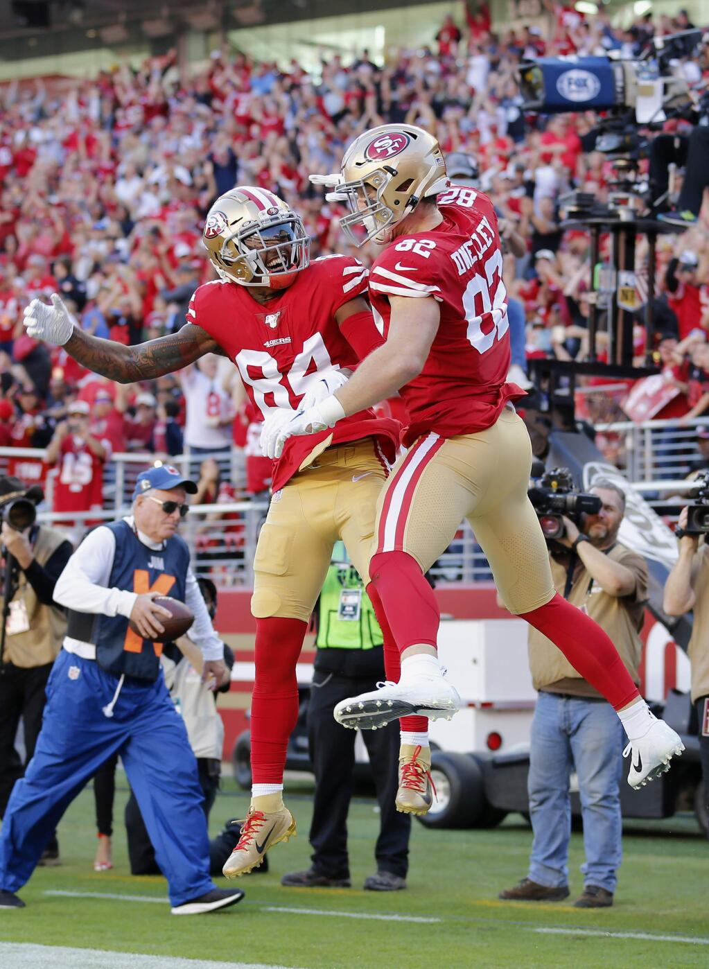San Francisco 49ers tight end Ross Dwelley, right, is congratulated by wide receiver Kendrick Bourne after scoring against the Arizona Cardinals during the first half of an NFL football game in Santa Clara, Calif., Sunday, Nov. 17, 2019. (AP Photo/Josie Lepe)