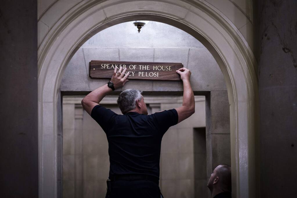 A sign is affixed to the entrance of the office of House Speaker Nancy Pelosi at the Capitol. (PETE MAROVICH / New York Times)