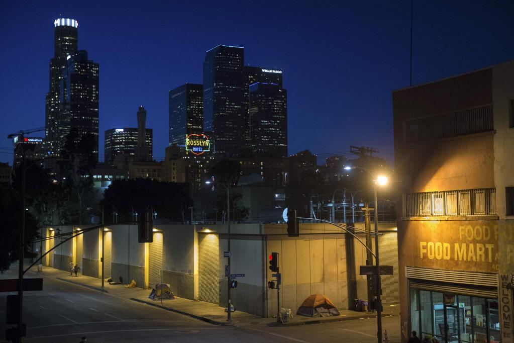 FILE - In this Monday, April 25, 2016 file photo, homeless people sleep in the Skid Row area in downtown Los Angeles. (AP Photo/Jae C. Hong, File)
