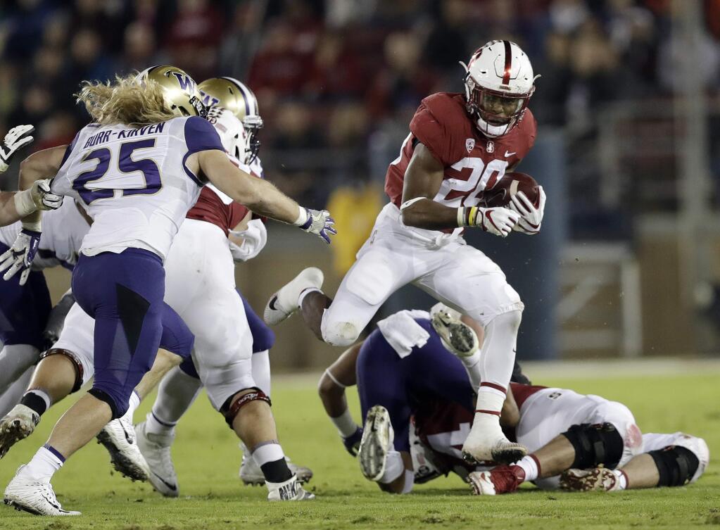 Stanford 's Bryce Love (20) runs against Washington during the first half of an NCAA college football game Friday, Nov. 10, 2017, in Stanford, Calif. (AP Photo/Marcio Jose Sanchez)