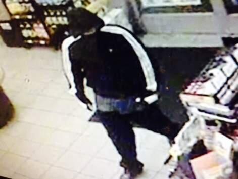 A still from a surveillance video shows a man suspected of holding up a convenience market and a gas station in Petaluma on Wednesday, March 25, 2015. (PETALUMA POLICE DEPARTMENT)