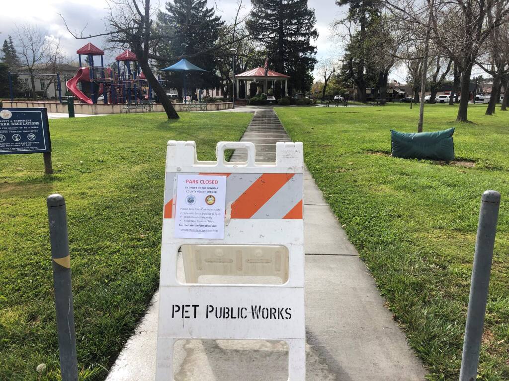 PARKS WITHOUT PEOPLE: Looking toward the playground at Walnut Park, where signs like these warn residents to stay clear of the park till further notice. (PHOTOS BY DAVID TEMPLETON)