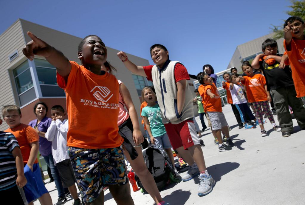 Zadok Jones, 8, left, shouts a song during Club Huddle time at the Boys and Girls Clubs of Central Sonoma County summer camp at Roseland Creek Elementary School in Santa Rosa, on Tuesday, July 14, 2015. (BETH SCHLANKER/ The Press Democrat)