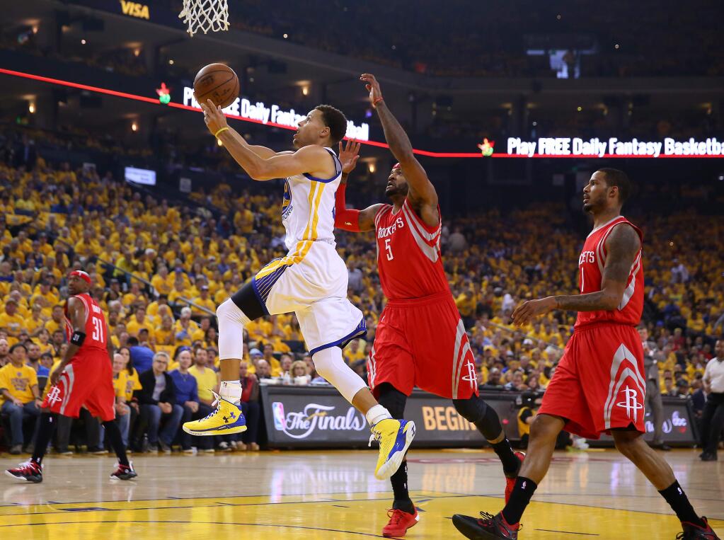 Golden State Warriors guard Stephen Curry is unable to finish the drive to the hoop against Houston Rockets forward Josh Smith during Game 2 of the NBA Western Conference final at Oracle Arena, in Oakland on Thursday, May 21, 2015. The Warriors defeated the Rockets 99-98. (Christopher Chung / The Press Democrat)