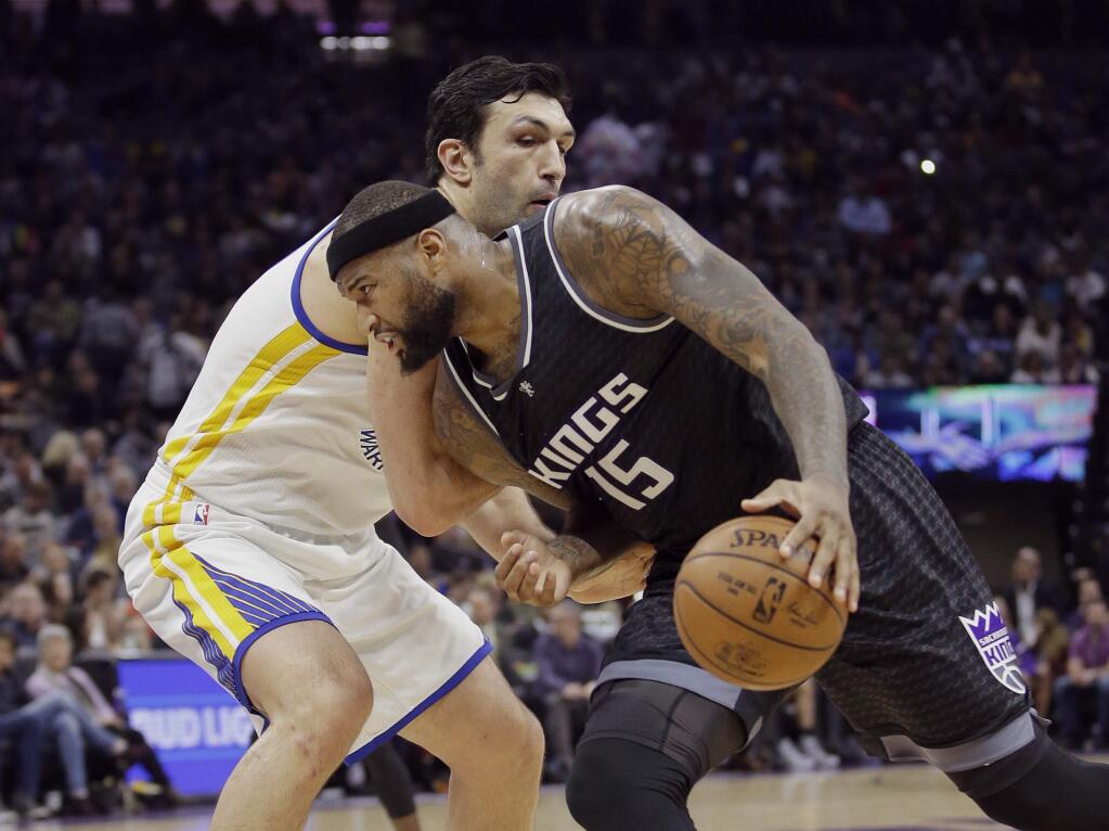 Sacramento Kings forward DeMarcus Cousins, right, drives to the basket against Golden State Warriors center Zaza Pachulia during the second half of an NBA basketball game Sunday, Jan. 8, 2017, in Sacramento, Calif. The Warriors won 117-106. (AP Photo/Rich Pedroncelli)